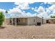 A view of the back of the home, featuring a covered patio, low maintenance yard and gravel landscaping at 8330 E Pueblo Ave, Mesa, AZ 85208