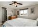 Comfortable bedroom with laminate flooring, a large window, and neutral wall decor providing a relaxing atmosphere at 8330 E Pueblo Ave, Mesa, AZ 85208