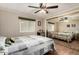 A roomy bedroom with a mirrored closet, ceiling fan, laminate flooring, and comfortable queen bed at 8330 E Pueblo Ave, Mesa, AZ 85208