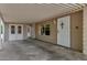 Covered carport featuring an exterior door and window to the main house for easy access at 8330 E Pueblo Ave, Mesa, AZ 85208