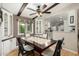 Dining area with hardwood floors, a modern table, and an adjacent kitchen area at 8330 E Pueblo Ave, Mesa, AZ 85208