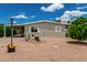 Charming home with a well-maintained yard, gravel landscaping, and a covered parking area at 8330 E Pueblo Ave, Mesa, AZ 85208