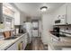 Bright kitchen with stone countertops, white cabinets, and stainless steel appliances at 8330 E Pueblo Ave, Mesa, AZ 85208