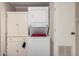Functional laundry area with stacked washer/dryer, storage cabinet, and convenient access at 8330 E Pueblo Ave, Mesa, AZ 85208