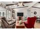 Spacious living room featuring hardwood floors, ceiling fan, and comfortable seating at 8330 E Pueblo Ave, Mesa, AZ 85208