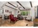Cozy living room with wood floors, ceiling fan, beamed ceiling and comfortable seating at 8330 E Pueblo Ave, Mesa, AZ 85208