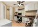 Bright home office with built-in cabinets, a large desk area, laminate flooring and comfortable office chair at 8330 E Pueblo Ave, Mesa, AZ 85208
