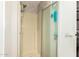 Clean shower stall featuring a glass door, tiled walls, and convenient storage shelves for toiletries at 8330 E Pueblo Ave, Mesa, AZ 85208