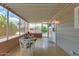 Cozy sun room with views of landscaped surroundings through screened windows at 8330 E Pueblo Ave, Mesa, AZ 85208