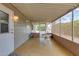 Enclosed sun room featuring screened windows, bright sunlight, and neutral colors at 8330 E Pueblo Ave, Mesa, AZ 85208
