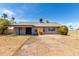 Expansive backyard featuring a covered patio, offering potential for outdoor living and entertaining on a sunny day at 8703 W Golden Ln, Peoria, AZ 85345