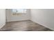 Bedroom featuring wood-look floors and a large window for ample natural light at 8703 W Golden Ln, Peoria, AZ 85345
