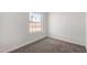 Clean bedroom featuring new carpeting and a large window for ample light at 8703 W Golden Ln, Peoria, AZ 85345