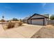 Spacious single-level home with desert landscaping, garage, and long driveway at 8703 W Golden Ln, Peoria, AZ 85345