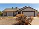 Charming single-level home with a neutral color scheme and a well-maintained front yard at 8703 W Golden Ln, Peoria, AZ 85345