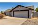 View of a single level home featuring an attached two-car garage at 8703 W Golden Ln, Peoria, AZ 85345