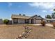View of single-level home with low maintenance landscaping at 8703 W Golden Ln, Peoria, AZ 85345