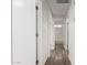 Hallway with wood floors and white doors providing access to rooms at 8703 W Golden Ln, Peoria, AZ 85345