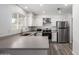 Kitchen with stainless steel appliances, modern countertops, and updated fixtures at 8703 W Golden Ln, Peoria, AZ 85345