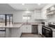 Well-lit kitchen with stainless steel dishwasher and plenty of counter space at 8703 W Golden Ln, Peoria, AZ 85345