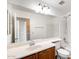 Bathroom vanity and mirror over a tub with shower at 9 N 87Th N Ln, Tolleson, AZ 85353