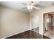 Bedroom with wood floors, ceiling fan and closet with mirrored doors at 9 N 87Th N Ln, Tolleson, AZ 85353