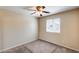 Bedroom with tan carpet, window with blinds and a ceiling fan at 9 N 87Th N Ln, Tolleson, AZ 85353