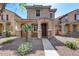 Charming two-story home featuring a covered entryway, a landscaped yard with decorative rock at 9 N 87Th N Ln, Tolleson, AZ 85353