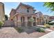 Charming two-story home with covered entryway, and a landscaped yard with desert rock and flowers at 9 N 87Th N Ln, Tolleson, AZ 85353
