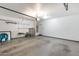 Spacious garage with ample storage shelves and an automatic door opener at 9 N 87Th N Ln, Tolleson, AZ 85353