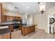 Open kitchen featuring wooden cabinets, stainless appliances, and a functional center island at 9 N 87Th N Ln, Tolleson, AZ 85353