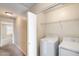 Convenient laundry room with washer, dryer, and added storage shelf at 9 N 87Th N Ln, Tolleson, AZ 85353