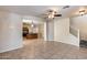 Living room with tile flooring, a ceiling fan, and views of the kitchen and staircase at 9 N 87Th N Ln, Tolleson, AZ 85353