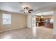 Open floorplan living room with tile flooring, a ceiling fan, and easy access to the kitchen at 9 N 87Th N Ln, Tolleson, AZ 85353