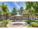 Scenic community park featuring a shaded gazebo with seating, surrounded by lush greenery and manicured landscaping at 9 N 87Th N Ln, Tolleson, AZ 85353