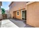 Private patio area with brick accents and a sliding glass door entrance into the home at 9 N 87Th N Ln, Tolleson, AZ 85353