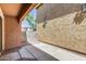 Covered patio with red brick accents and view to the greenery and sky at 9 N 87Th N Ln, Tolleson, AZ 85353