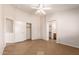 Spacious bedroom featuring tile floors, white walls, a closet, and an ensuite bathroom at 9332 W Mary Ann Dr, Peoria, AZ 85382