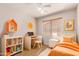 A colorful bedroom furnished with a desk, bed, and decorative shelves at 9332 W Mary Ann Dr, Peoria, AZ 85382