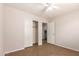 A minimalist bedroom with a closet and doorway to a laundry area and neutral walls at 9332 W Mary Ann Dr, Peoria, AZ 85382