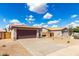 Charming single-story home featuring a two-car garage, low maintenance landscaping, and tile roof at 9332 W Mary Ann Dr, Peoria, AZ 85382