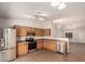 Kitchen area featuring stainless appliances, wooden cabinets, tile backsplash, and an open concept layout at 9332 W Mary Ann Dr, Peoria, AZ 85382