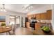 Eat-in kitchen featuring stainless appliances, wood cabinets, and sliding doors to the backyard at 9332 W Mary Ann Dr, Peoria, AZ 85382