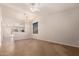 Open-concept living room featuring tile floors, high ceilings, neutral walls, and plenty of natural light at 9332 W Mary Ann Dr, Peoria, AZ 85382