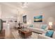 Bright living room featuring a vaulted ceiling, neutral paint, and views into the dining and kitchen areas at 9332 W Mary Ann Dr, Peoria, AZ 85382