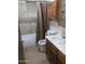 Bathroom featuring a shower/tub combo, vanity and built-in cabinet at 108 E Jasmine St, Mesa, AZ 85201