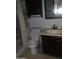 Standard bathroom with shower/tub combo and dark cabinets, providing functionality at 108 E Jasmine St, Mesa, AZ 85201