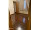 This bedroom features laminate floors, a window, and closet space at 108 E Jasmine St, Mesa, AZ 85201