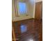 Bedroom featuring laminate floors, a window, and closet space at 108 E Jasmine St, Mesa, AZ 85201