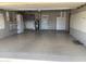 Spacious garage features sealed concrete floors, cabinets for storage, utility sink, and pegboard for tool organization at 108 E Jasmine St, Mesa, AZ 85201
